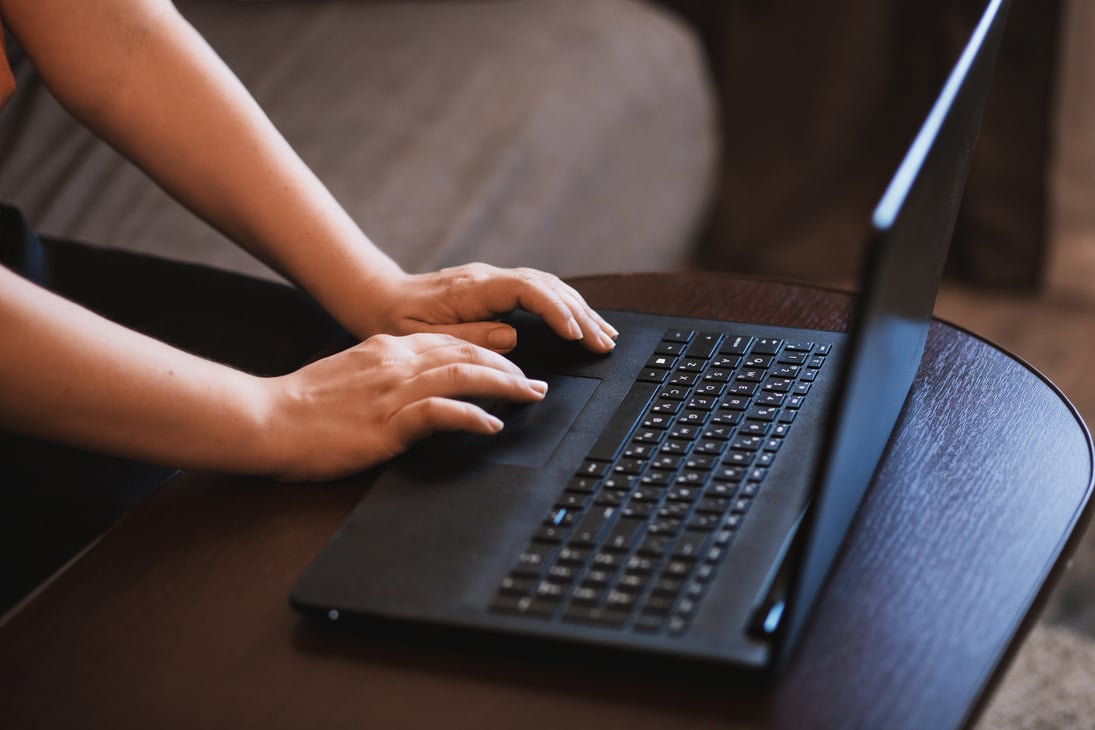 Person Working on Black Laptop.